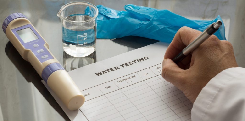 Hand,Writing,On,A,Water,Test,Sheet.,Water,Quality,Measuring